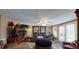 Relaxing living room with dark leather furniture, indoor plants and backyard access at 2901 Briscoe Rd, Loganville, GA 30052