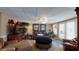 A comfortable living room boasts a large leather sofa, a decorative ottoman, and ample seating for relaxation at 2901 Briscoe Rd, Loganville, GA 30052