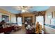Bright office space with a wooden desk, ceiling fan, and decorative art at 2901 Briscoe Rd, Loganville, GA 30052