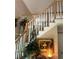 Staircase with white spindles, a wooden handrail, and attractive decor at 2901 Briscoe Rd, Loganville, GA 30052