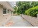 Large concrete back patio with brick railing and walls is ideal for outdoor living and entertainment at 2957 Browns Mill Se Rd, Atlanta, GA 30354