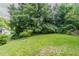 Beautiful backyard with lush green grass and a line of large trees at 2957 Browns Mill Se Rd, Atlanta, GA 30354