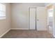 Bedroom featuring neutral paint and carpet, window and closet at 2957 Browns Mill Se Rd, Atlanta, GA 30354