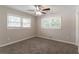 Bedroom featuring carpet flooring, neutral walls, a ceiling fan, and two windows at 2957 Browns Mill Se Rd, Atlanta, GA 30354