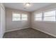 Cozy bedroom with fresh paint, carpet, a closet, and windows with blinds at 2957 Browns Mill Se Rd, Atlanta, GA 30354