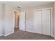 Bright bedroom featuring neutral walls, carpet flooring, and closet with folding doors at 2957 Browns Mill Se Rd, Atlanta, GA 30354