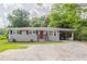 Charming one-story home with red front door, light brick, and attached carport at 2957 Browns Mill Se Rd, Atlanta, GA 30354