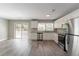 Well-lit kitchen with stainless appliances, white cabinets, granite countertops, and glass doors to patio at 2957 Browns Mill Se Rd, Atlanta, GA 30354