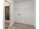 Mud room with plank flooring, white walls, and a metal shelf at 2957 Browns Mill Se Rd, Atlanta, GA 30354