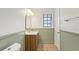 Bathroom with vanity, mirror, window, and neutral colors at 355 Winding River Dr # B, Atlanta, GA 30350