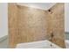 Bathtub features tile surround and shower head at 355 Winding River Dr # B, Atlanta, GA 30350