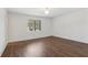 Bright bedroom features hardwood floors, white walls, trim and a window at 355 Winding River Dr # B, Atlanta, GA 30350
