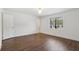 This bedroom features hardwood floors and a window at 355 Winding River Dr # B, Atlanta, GA 30350