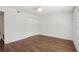 Spacious bedroom with light walls, modern lighting, and brown flooring at 355 Winding River Dr # B, Atlanta, GA 30350