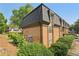 Exterior view of the brick apartment building with mature landscaping at 355 Winding River Dr # B, Atlanta, GA 30350
