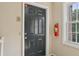 Apartment B's front door with gray paint, peephole, intercom and fire extinguisher at 355 Winding River Dr # B, Atlanta, GA 30350