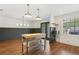 Bright kitchen with stainless steel island, modern lighting, and gray accent wall at 355 Winding River Dr # B, Atlanta, GA 30350