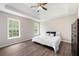 Bright bedroom with tray ceiling, hardwood floors, and two windows at 76 Vaughn Ne Rd, Cartersville, GA 30121