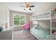 Bright bedroom features a bunk bed, large window and a ceiling fan at 76 Vaughn Ne Rd, Cartersville, GA 30121