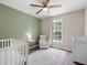 Cozy Bedroom with crib, recliner, and large window at 76 Vaughn Ne Rd, Cartersville, GA 30121