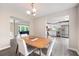Open-concept dining room featuring a modern chandelier and views of the kitchen and living room at 76 Vaughn Ne Rd, Cartersville, GA 30121