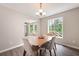 Dining area boasts a window view and stylish light fixture at 76 Vaughn Ne Rd, Cartersville, GA 30121