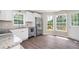 Bright kitchen features stainless steel appliances, white cabinets, and an eat-in dining area at 76 Vaughn Ne Rd, Cartersville, GA 30121