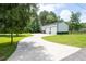 A large detached shop features a concrete driveway and 3-car garage capacity at 76 Vaughn Ne Rd, Cartersville, GA 30121