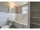 Bathroom featuring white tile, white sink, and built in shelving at 1391 Jefferson Ave, East Point, GA 30344