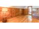 Bedroom with a cool retro vibe with hardwood floors and knotty pine walls and trim at 1391 Jefferson Ave, East Point, GA 30344