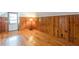 Bedroom with a cool retro vibe with hardwood floors and knotty pine walls and door to outside at 1391 Jefferson Ave, East Point, GA 30344