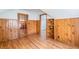 Upstairs bedroom with wood paneling, hardwood floors, and glass paned door at 1391 Jefferson Ave, East Point, GA 30344