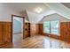 Upstairs bedroom featuring wood paneling, hardwood floors, and built in shelving at 1391 Jefferson Ave, East Point, GA 30344