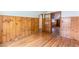 Upstairs bedroom featuring wood paneling, hardwood floors, and glass paned door at 1391 Jefferson Ave, East Point, GA 30344