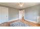 Bedroom with hardwood floors, a ceiling fan, natural light, neutral wall colors, and door to hall at 1391 Jefferson Ave, East Point, GA 30344