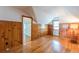 Bedroom with a cool retro vibe with hardwood floors and knotty pine walls and door to hall at 1391 Jefferson Ave, East Point, GA 30344