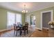 Cozy dining room with hardwood floors, chandelier, and natural light, creating a warm ambiance at 1391 Jefferson Ave, East Point, GA 30344