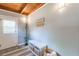Cozy entryway featuring a white bench with storage baskets, hooks, and a charming 