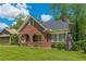 Charming brick home with a beautiful lawn and arched porch perfect for relaxing and enjoying the outdoors at 1391 Jefferson Ave, East Point, GA 30344