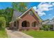 Charming brick home featuring a well-maintained front yard, arched porch and inviting curb appeal at 1391 Jefferson Ave, East Point, GA 30344