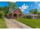 Charming brick home featuring a well-maintained front yard, arched porch and inviting curb appeal at 1391 Jefferson Ave, East Point, GA 30344