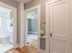 Hallway view showing doors to the bathroom and bedroom with hardwood floors and neutral wall colors at 1391 Jefferson Ave, East Point, GA 30344