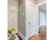 Hallway with beautiful hardwood floors, white trim, built in storage and neutral wall colors at 1391 Jefferson Ave, East Point, GA 30344