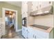 Bright kitchen with white cabinets, modern stainless steel appliances, butcher block counters, and tile flooring at 1391 Jefferson Ave, East Point, GA 30344