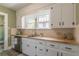 Traditional-style kitchen with white cabinets, butcher block countertops, and stainless steel appliances at 1391 Jefferson Ave, East Point, GA 30344