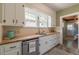 Modern kitchen with sleek butcher block countertops, white cabinets, and stainless steel dishwasher at 1391 Jefferson Ave, East Point, GA 30344