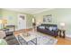 Well-lit living room showcasing hardwood floors, comfortable seating, and an open layout at 1391 Jefferson Ave, East Point, GA 30344