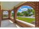 View from porch with brick arches overlooking well-manicured lawn and sidewalk at 1391 Jefferson Ave, East Point, GA 30344