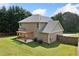 Aerial view of the home's backyard with a pergola, large lawn, and mature trees at 174 Randall Dr, Rockmart, GA 30153