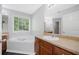 Primary bathroom with soaking tub, wood cabinets, and large mirror at 174 Randall Dr, Rockmart, GA 30153